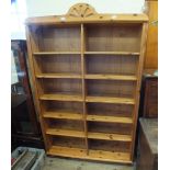 A modern pine open bookcase with twelve shelves