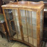 A 1930's china display cabinet with concave astral glazed doors