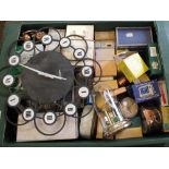A box of various small clocks