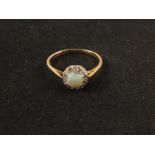 An 18ct gold opal and diamond ring marked MB Co (damage to opal)