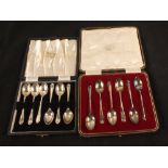 Two cased sets of six silver coffee spoons