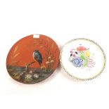 A Wedgwood terracotta plate painted with a kingfisher and a Poole floral plate