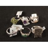Six silver stone set rings including emerald, peridot, pearl,
