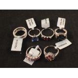 Six silver stone set rings including garnet, spinel,