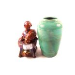 A Royal Doulton green glazed vase with relief face decoration plus a boy and rabbit group