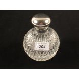 A silver top cut glass scent bottle