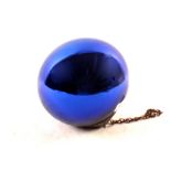 A blue glass witches ball,