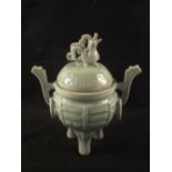 A Celadon glazed lidded jar with dragon finial