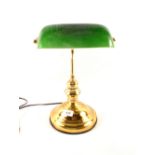 A brass students lamp with green shade