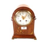 An Edwardian mahogany and brass inlaid dome top striking mantel clock