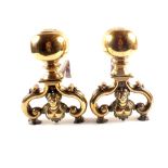 A pair of 19th Century brass and steel andirons with large balls and female torso decoration