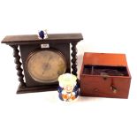 An oak cased aneroid barometer with barley twist columns,