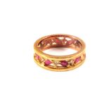 A 9ct gold band ring set with red and white stones,