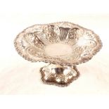 An embossed silver cake stand,