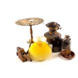 A brass oil lamp with yellow satin glass shade,