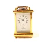 A brass carriage clock, dial marked Widdup,