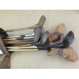 A bag of vintage golf clubs including some hickory shafts