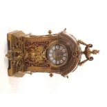 A brass cased mantel clock with winged cherub,