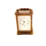 A brass carriage clock marked R & Co Made in Paris