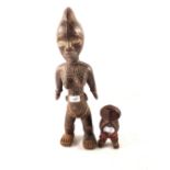 A West African maternity figure with beads plus an East African tribal figure with beads