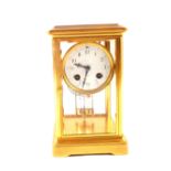 A brass cased four glass striking mantel clock with mercury pendulum