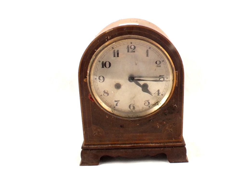 An Edwardian inlaid mahogany striking mantel clock