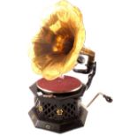 A phonograph with brass horn in octagonal ebonised case