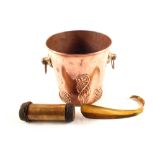 A copper ice bucket with embossed floral decoration,