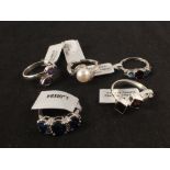 A group of five silver stone set rings including quartz,