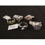 A group of five silver stone set rings including tanzanite and diamond, amethyst,