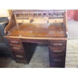 An Edwardian oak roll top desk