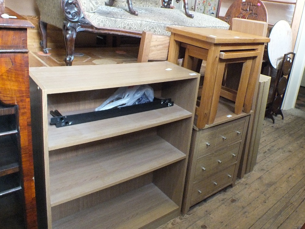 A nest of oak tables, a bookcase,