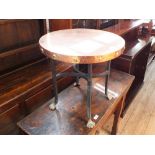 A circular copper topped table on lion claw feet