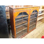 A Victorian flame mahogany and cross banded cabinet with two astragal glazed doors