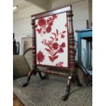 A Victorian mahogany woolwork floral fire screen on barley twist supports