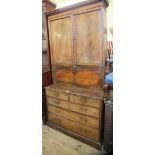 A 19th Century mahogany cupboard top secretaire chest over two short and three long drawers
