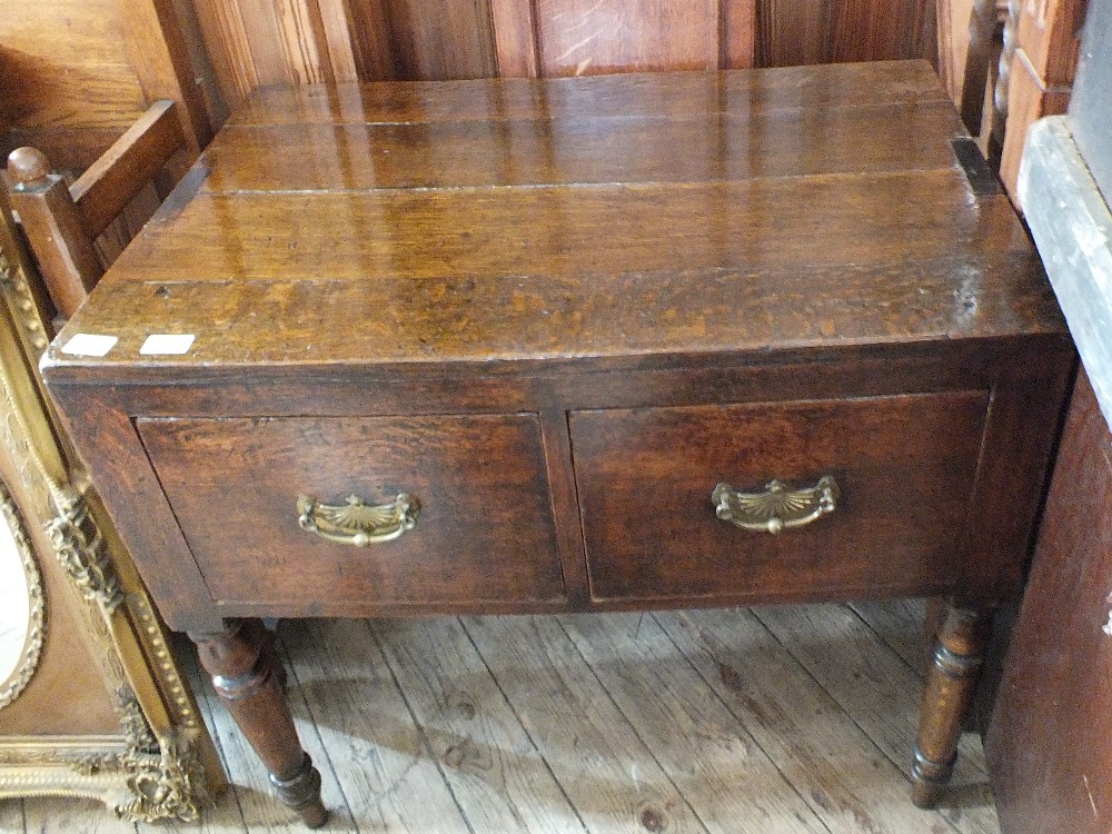 A Georgian oak two drawer chest on turned legs (formally a linen press)
