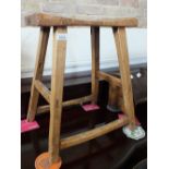 A rustic light wood stool two book racks plus a circular mahogany table