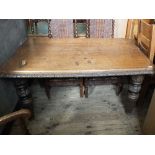 A Victorian carved oak dining table on bulbous and carved fluted legs