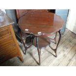 An Edwardian shaped topped two tier occasional table