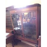 A mahogany astragal glazed two door bookcase on cabriole legs with claw and ball feet