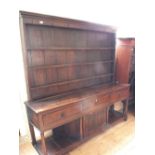 A 19th Century shelf back dresser with three drawers,