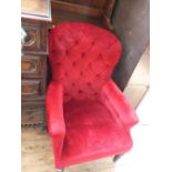 A Victorian red upholstered button back armchair