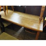 A rectangular pine farm house kitchen table