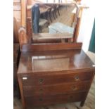 An oak three drawer dressing table plus an upholstered arm chair