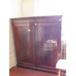 A Victorian flame mahogany two door wardrobe over two short and two long drawers