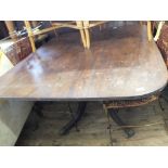 A 19th Century mahogany tilt top dining table on turned column on quatrefoil base