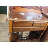 A reproduction mahogany three drawer side table and a small cane chest of two drawers