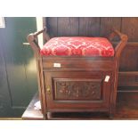 An Edwardian carved mahogany piano stool with upholstered top