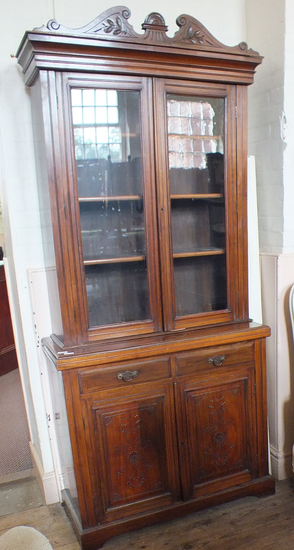 An Edwardian mahogany glazed two door sideboard bookcase